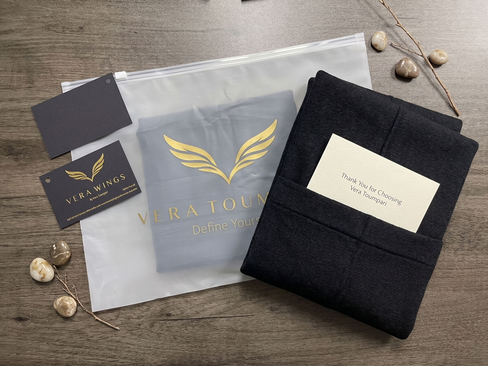 Vera Toumpari premium unboxing experience: custom zipper bag, folded garment, and thank you note